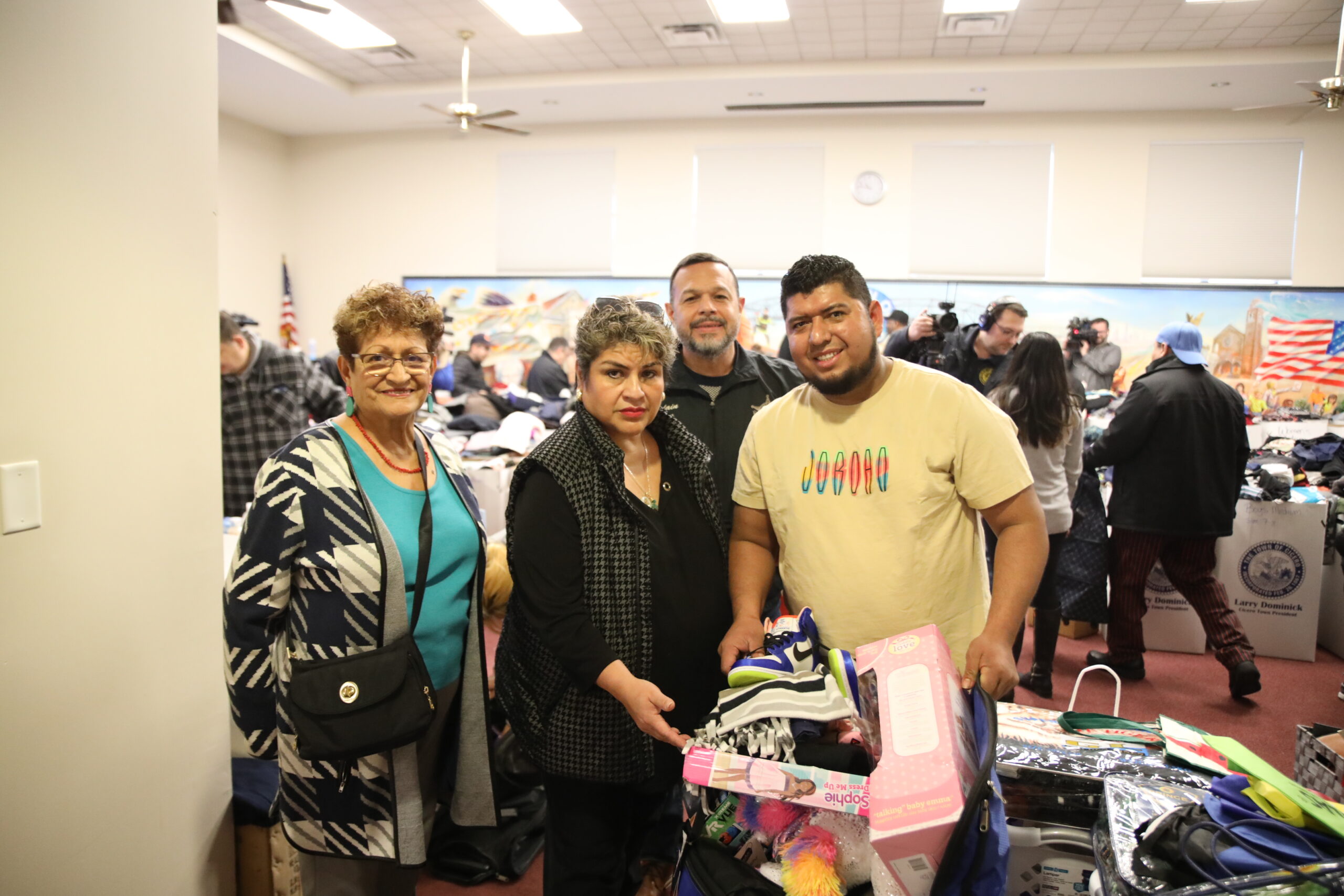 Trustee Blanca Vargas, Clerk Maria Punzo Arias and Chaplain Ismael Vargas work with victims of the Dec. 1, 2023 apartment building fire to replenish their belongings
