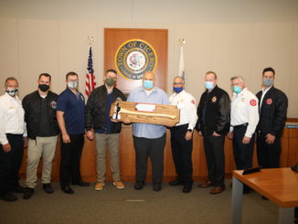 Town President Larry Dominick receives a "Fiefighter's Axe" from the Cicero Firefighters and from union leaders for his strong support of the Fire Department. Photo courtesy of the Town of Cicero and Gerardo Lopez.
