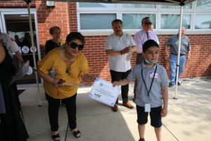Clerk Maria Punzo-Arias presents a Certificate to a student in one of the most recent classes at Safety Town Park, May 11, 2022