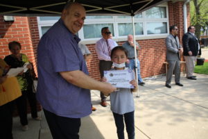 President Dominick presents a Certificate to a student in one of the most recent classes at Safety Town Park, May 11, 2022