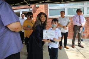 Diana Dominick, Director of the Senior Center and supervisor of the renovation of Safety Town Park, presents a Certificate to a student in one of the most recent classes at Safety Town Park, May 11, 2022