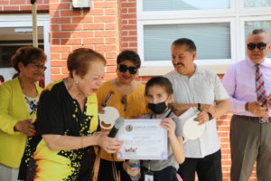 Donor Pat Deganutti presents a Certificate to a student in one of the most recent classes at Safety Town Park, May 11, 2022