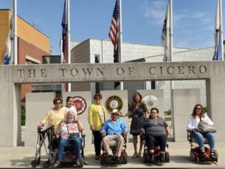 Senior Director Diana Dominick and Trustee Blanca Vargas present motorized wheel chairs to several seniors who needed mobility assistance