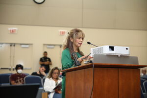 Senior Director Diana Dominick reads a letter of gratitude presented to members of Team Rubicon at the Town of Cicero Board meeting August 8, 2023