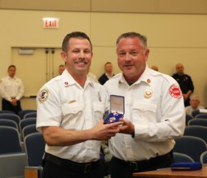 Fire Chief Jeff Penzkofer (right) presents Medal of Valor to Firefighter Lt. Bradley Erickson, Tuesday. May 28, 2024